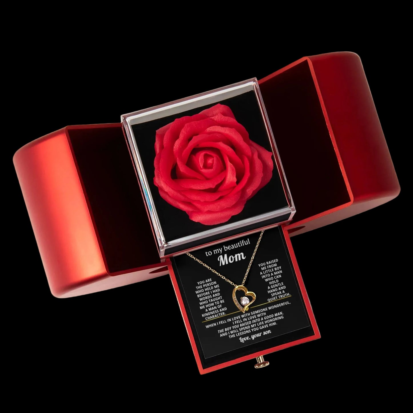 Red rose in a jewelry box with a necklace and card inside on a gray background